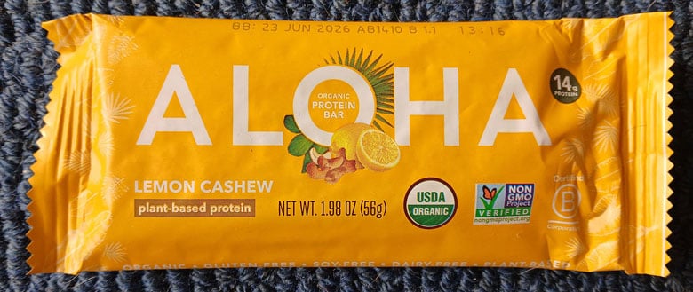 Front of Aloha protein bar label showing white logo on yellow background.